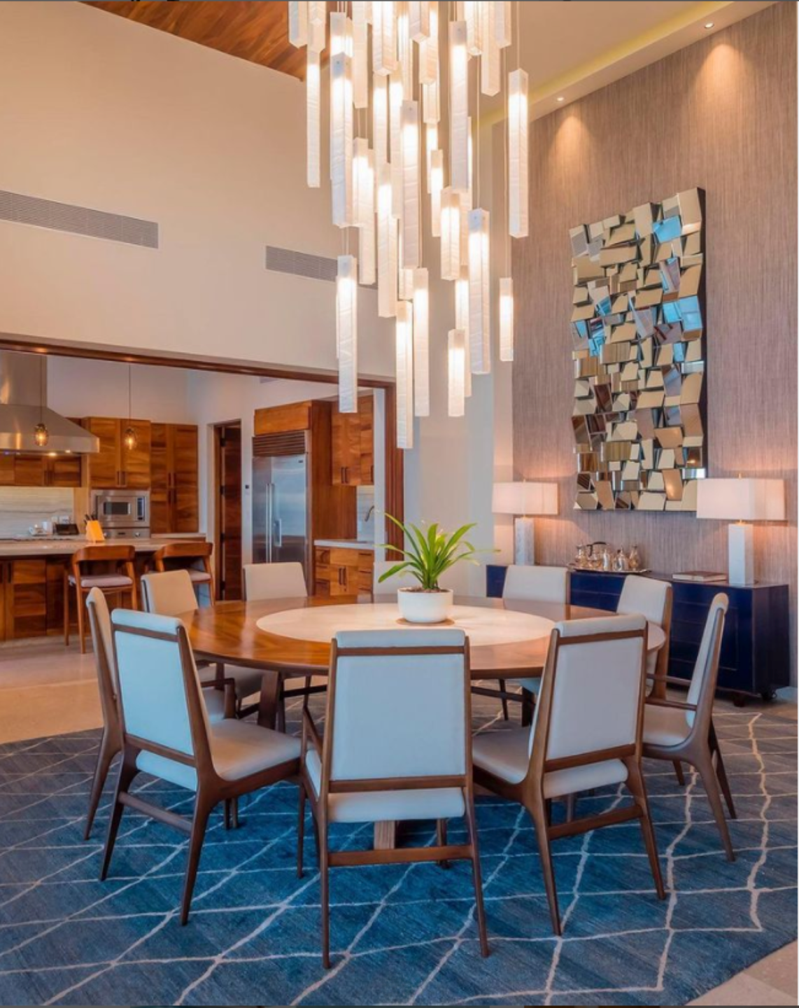 Luxury glass chandelier designed for the dining area, complementing the warm wood and contemporary interior.