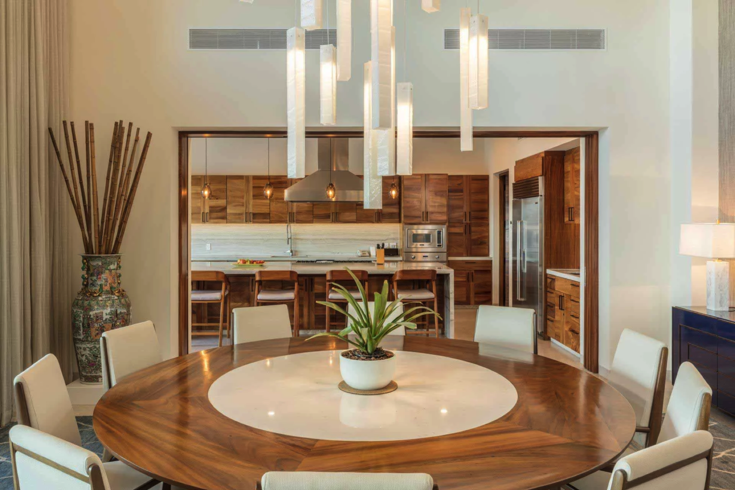 Close view of the handcrafted glass chandelier above the dining table, individually designed for Villa Marselina.