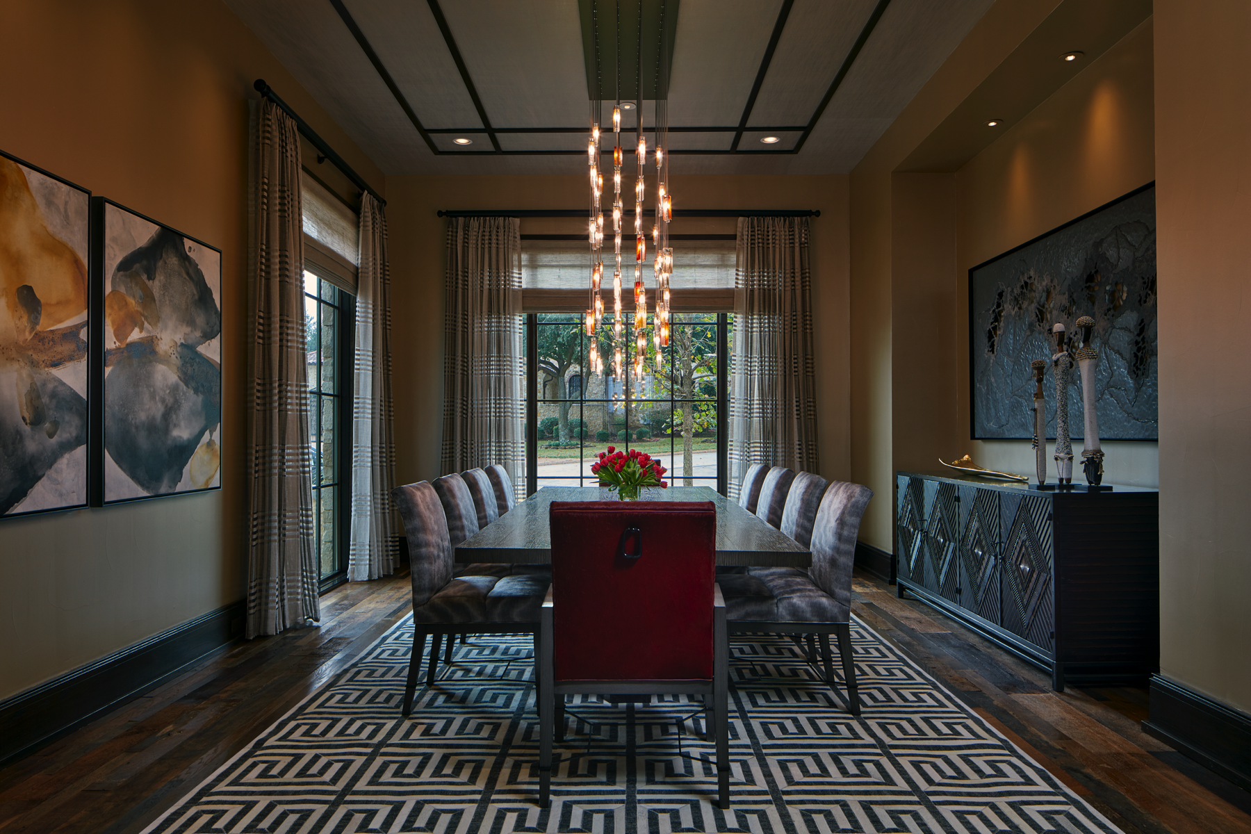 Custom art glass chandelier creating a dramatic focal point in the dining room.
