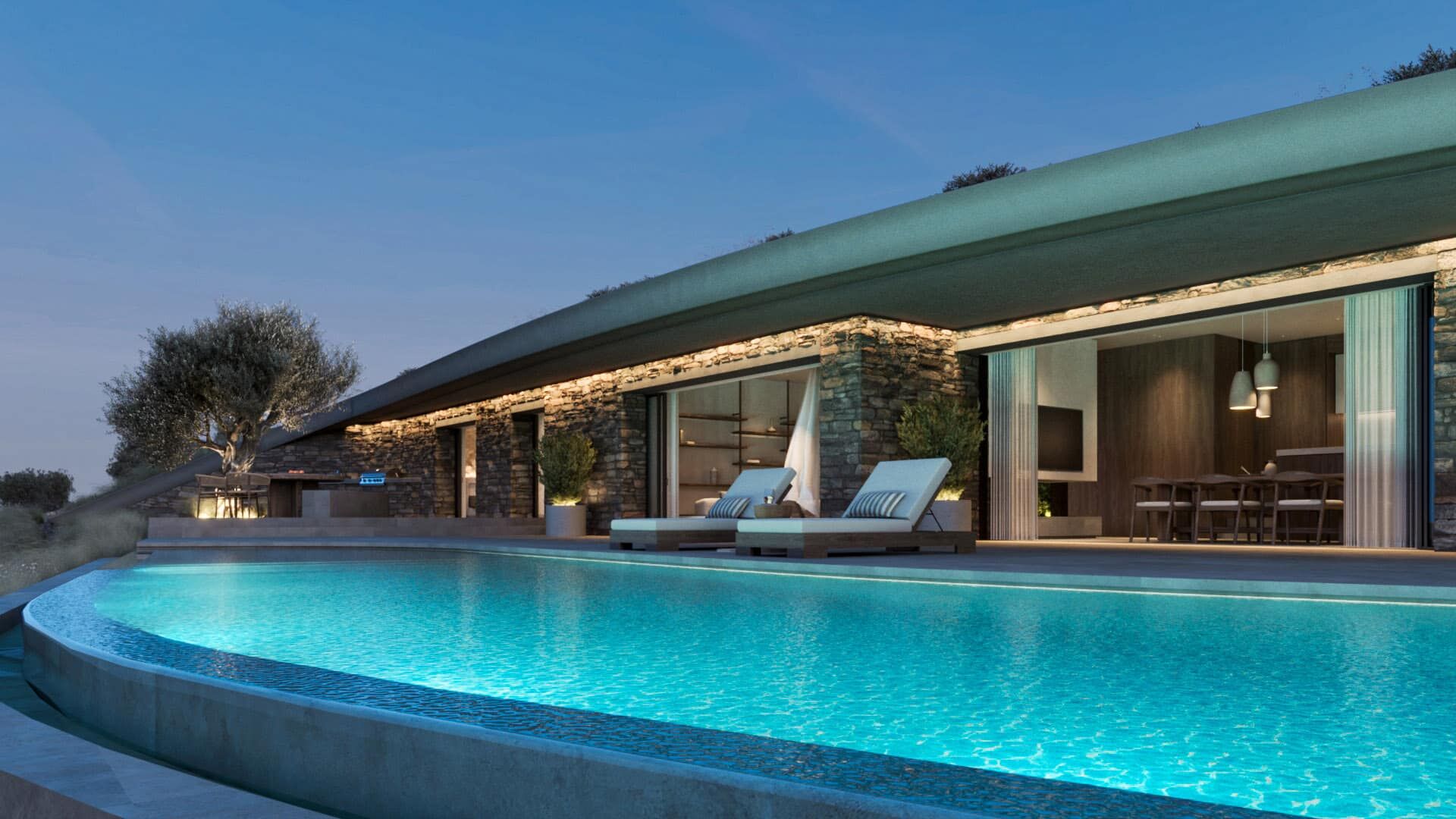1. Private pool terrace at dusk, framed by stone walls and the planted roof.
