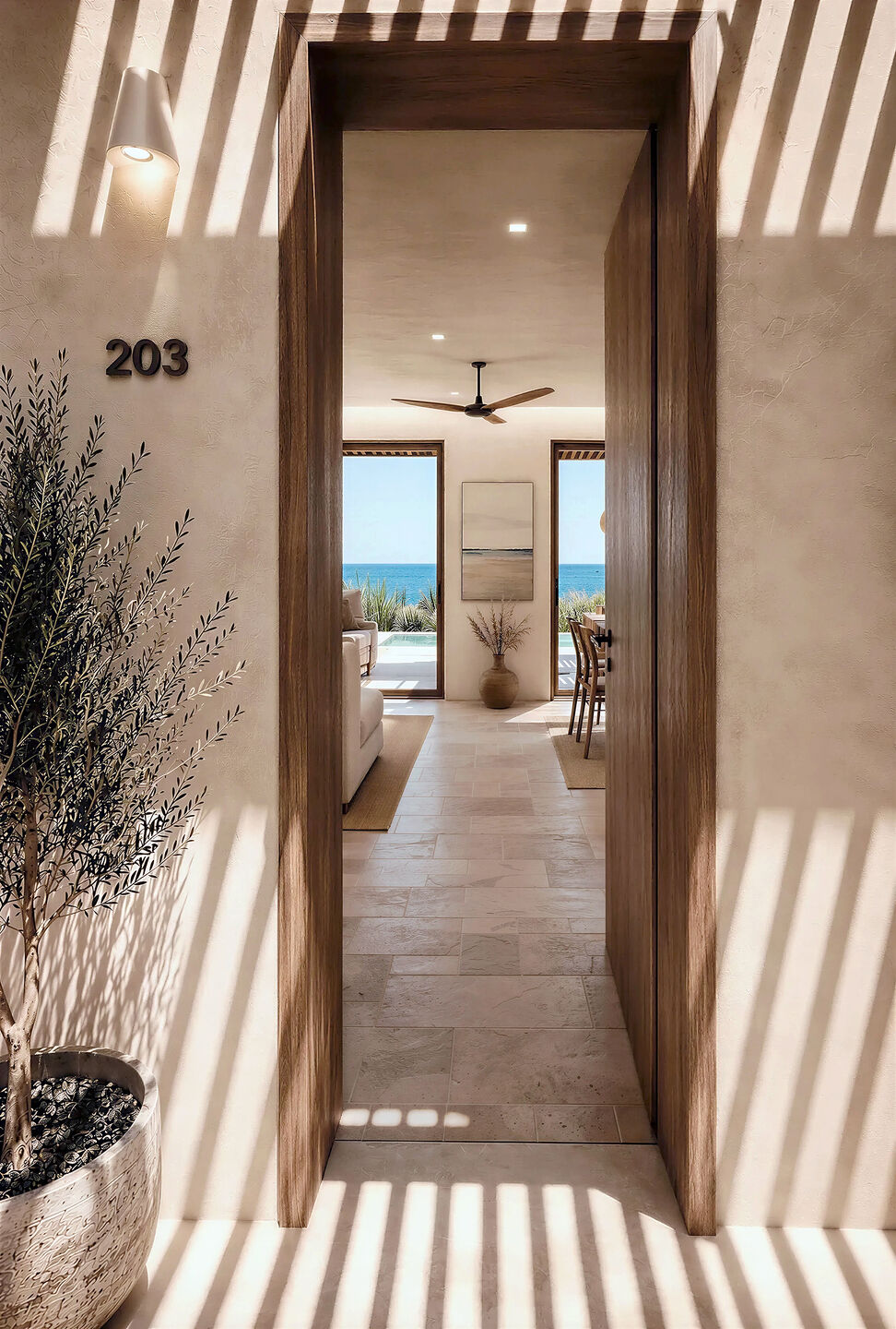 Interior passage framing views towards the sea and outdoor terrace.
