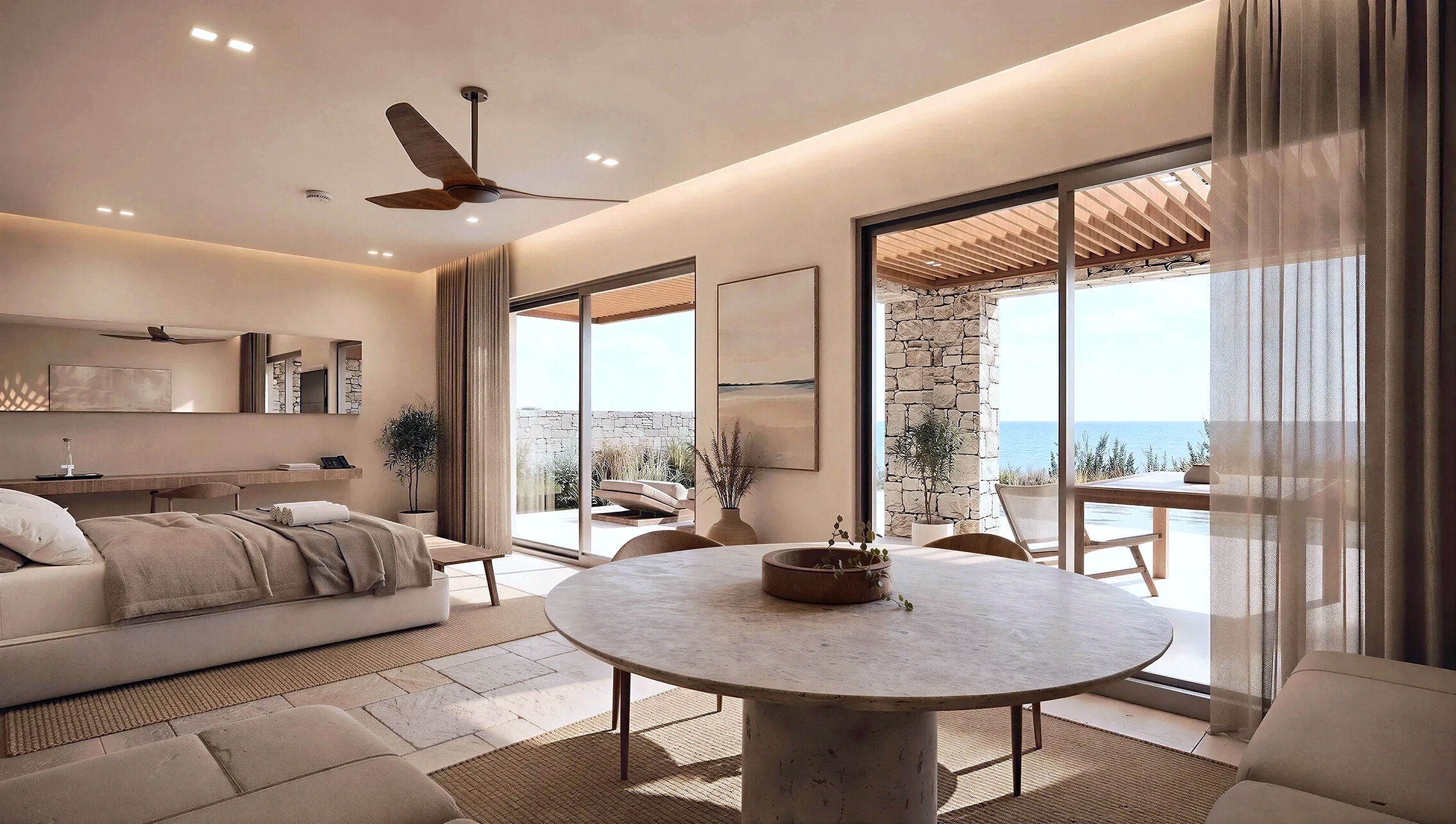 Guestroom living area opening onto a private terrace with sea views.
