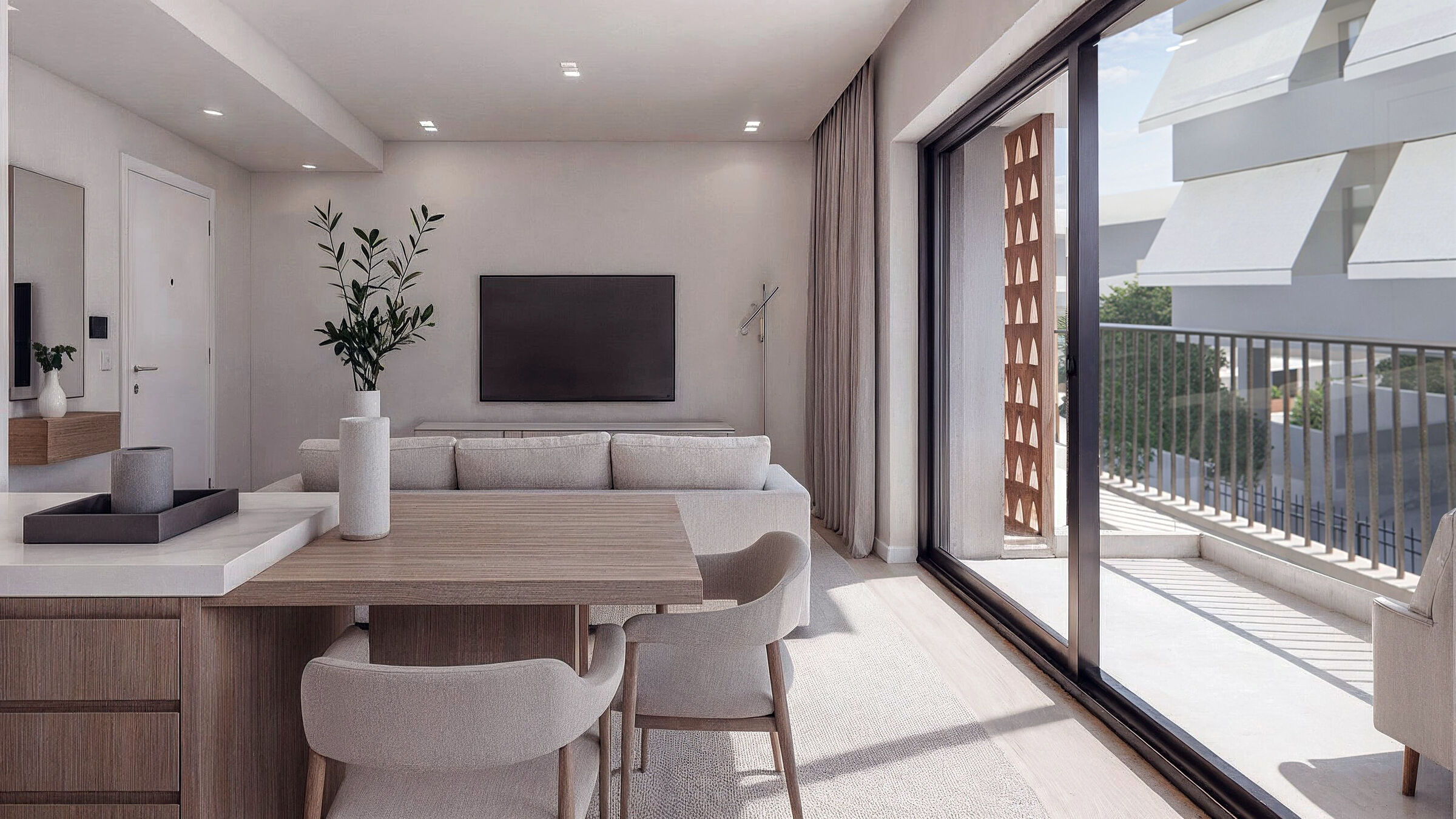 Living area opening onto the balcony through full-height glazing.