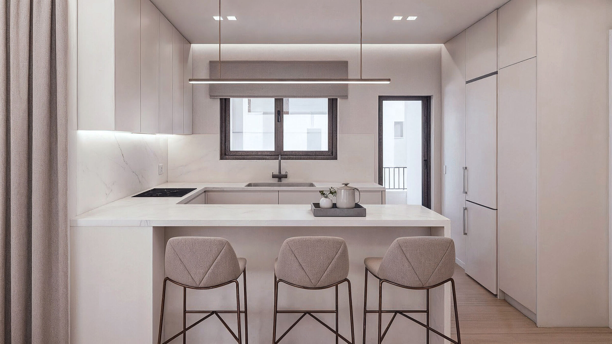Contemporary kitchen organized around a central island and a restrained material palette.