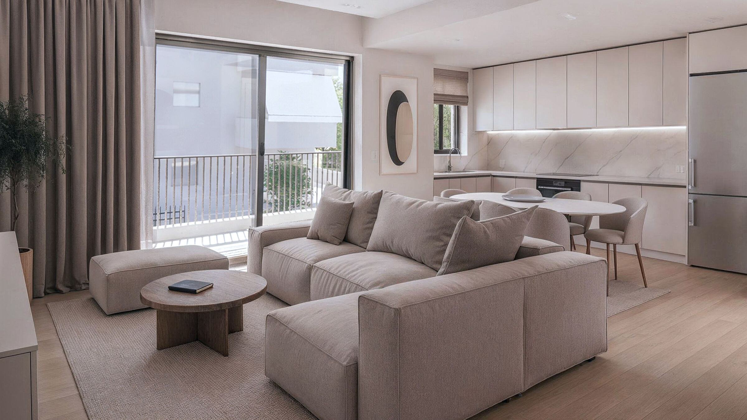 Open-plan living and dining area connected to the balcony and natural light.