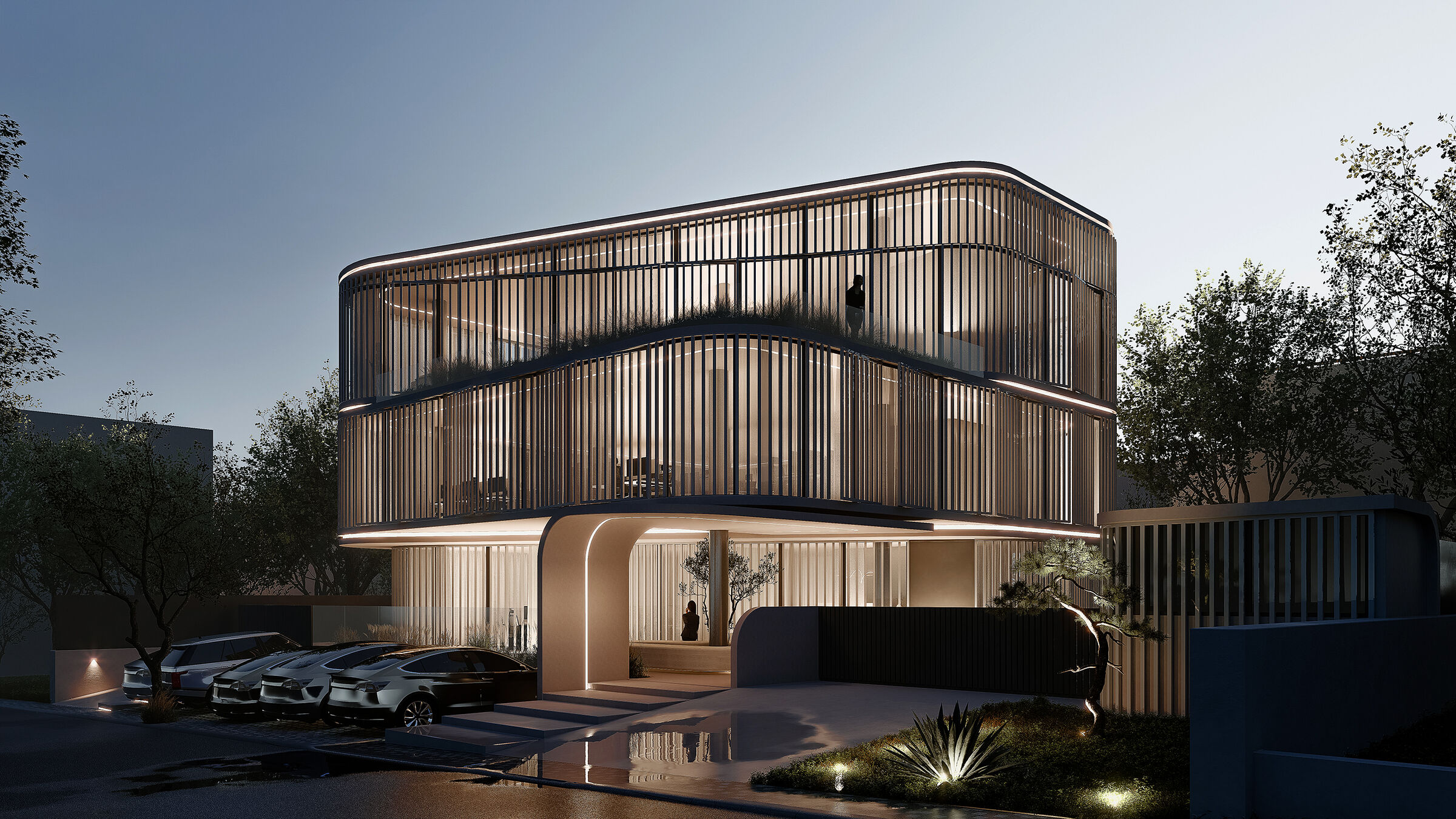 The projecting office volume frames the recessed entrance, marking the arrival to the building.