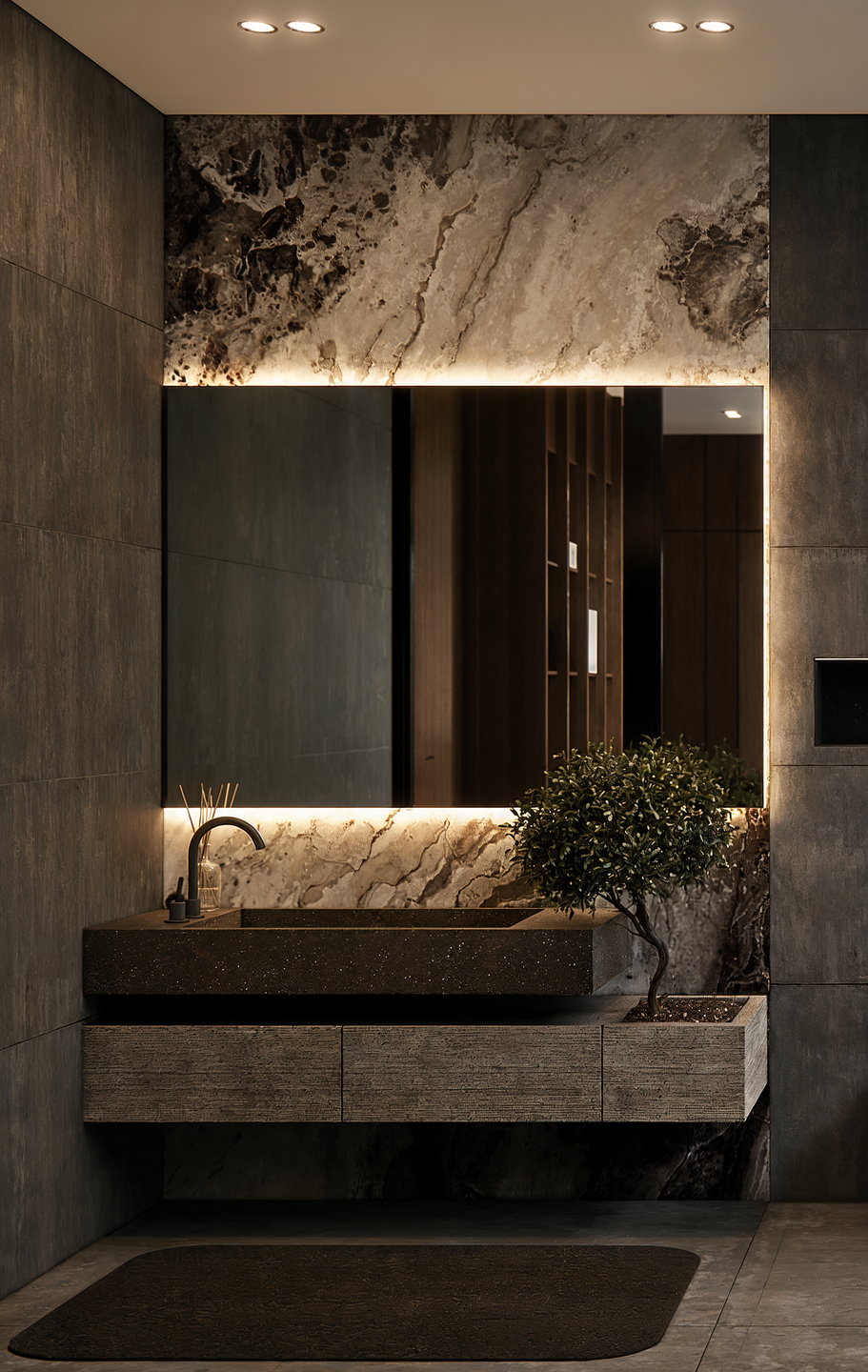 Layered natural stone, a floating vanity, and integrated architectural lighting create a tactile composition that balances material richness with minimal detailing.