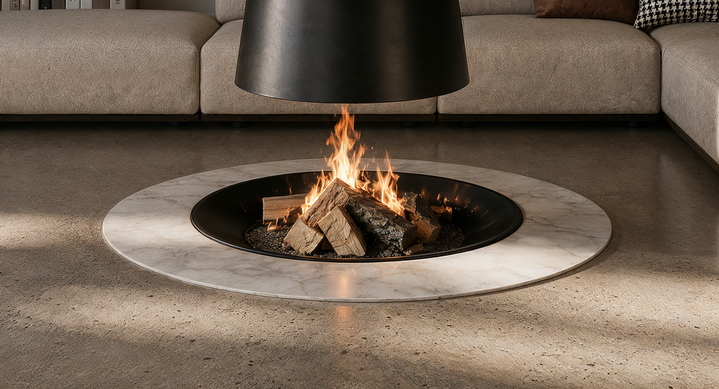 The fireplace's suspended form creates a distinctive focal point, where exposed flames and natural stone establish a refined dialogue between material, warmth, and geometry.