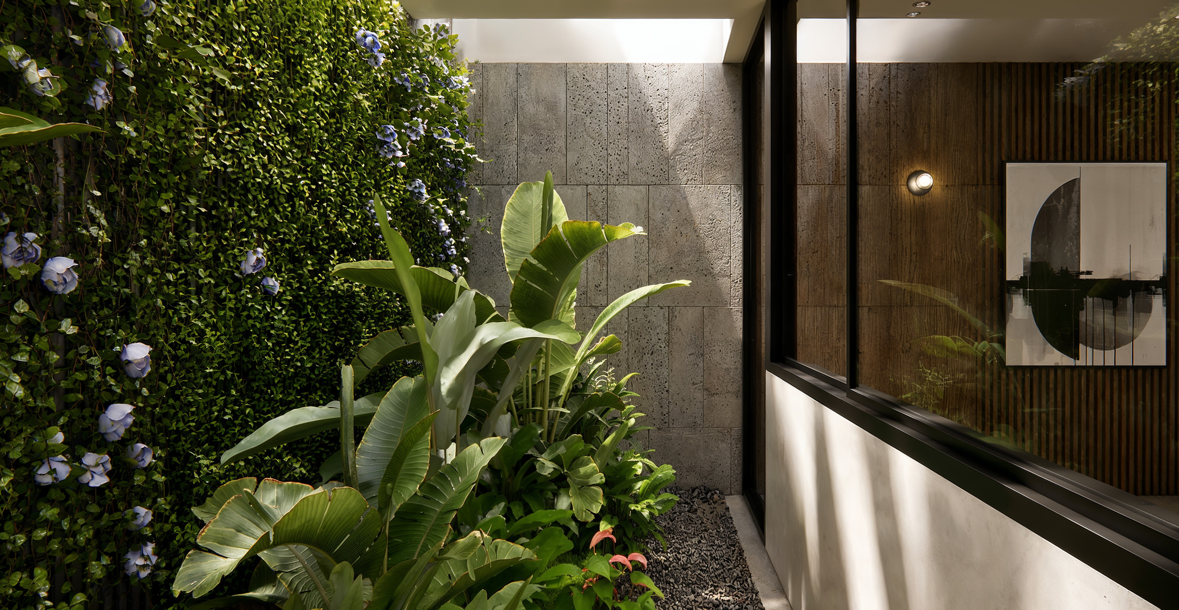 A private planted courtyard introduces greenery and natural textures into the residence, strengthening the relationship between interior architecture and the surrounding environment.